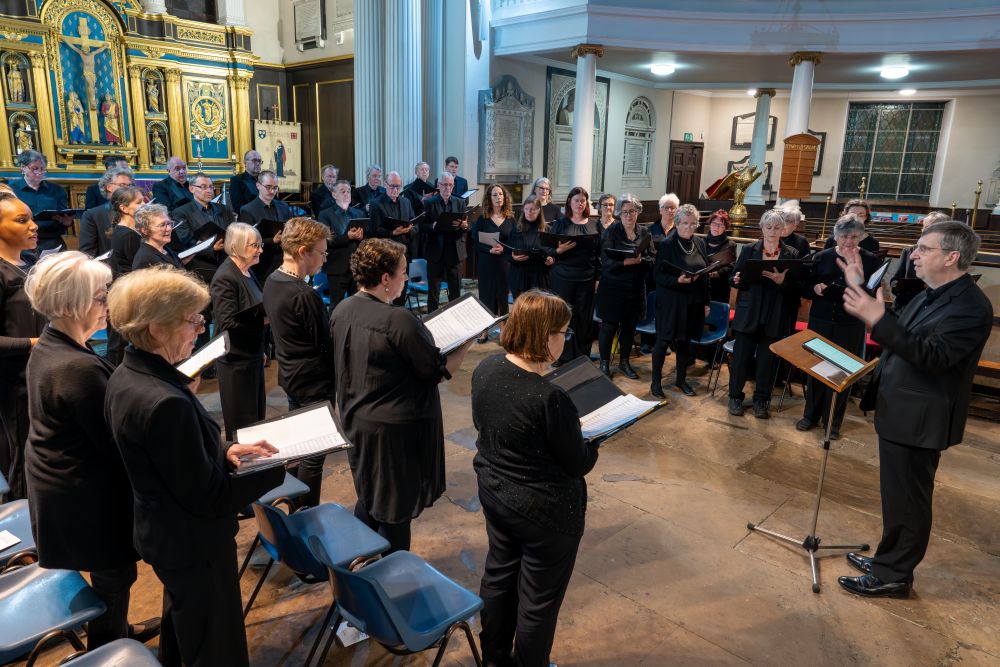 David Thomas rehearsing the choir in St Chad's Church in 2024